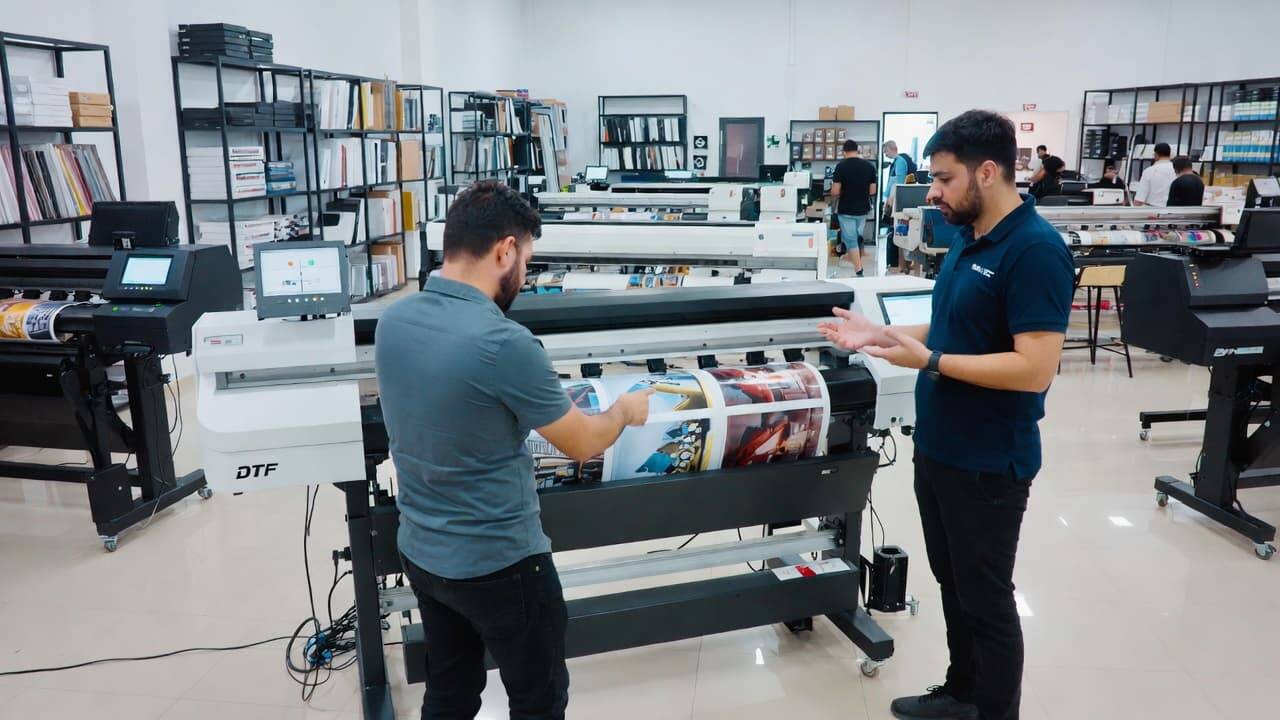 Customer discussing DTF printer features with sales representative in showroom