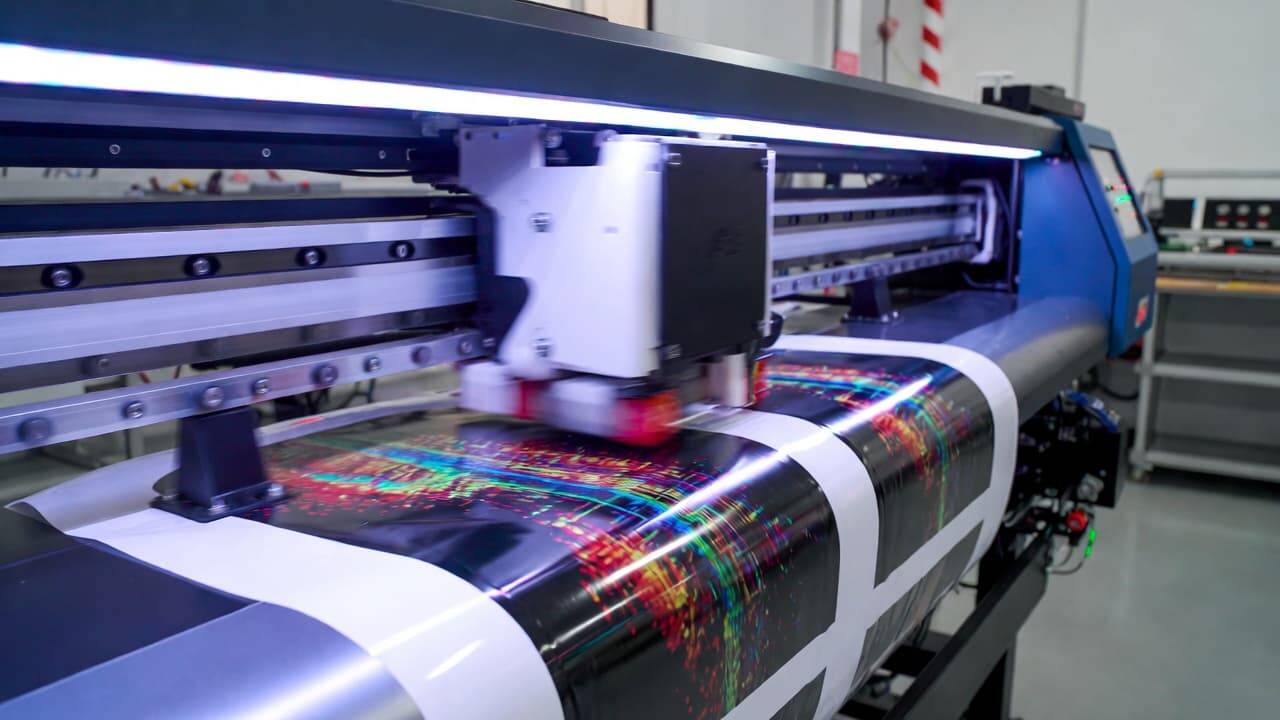 UV DTF printer printing vibrant design on transfer film with UV curing light