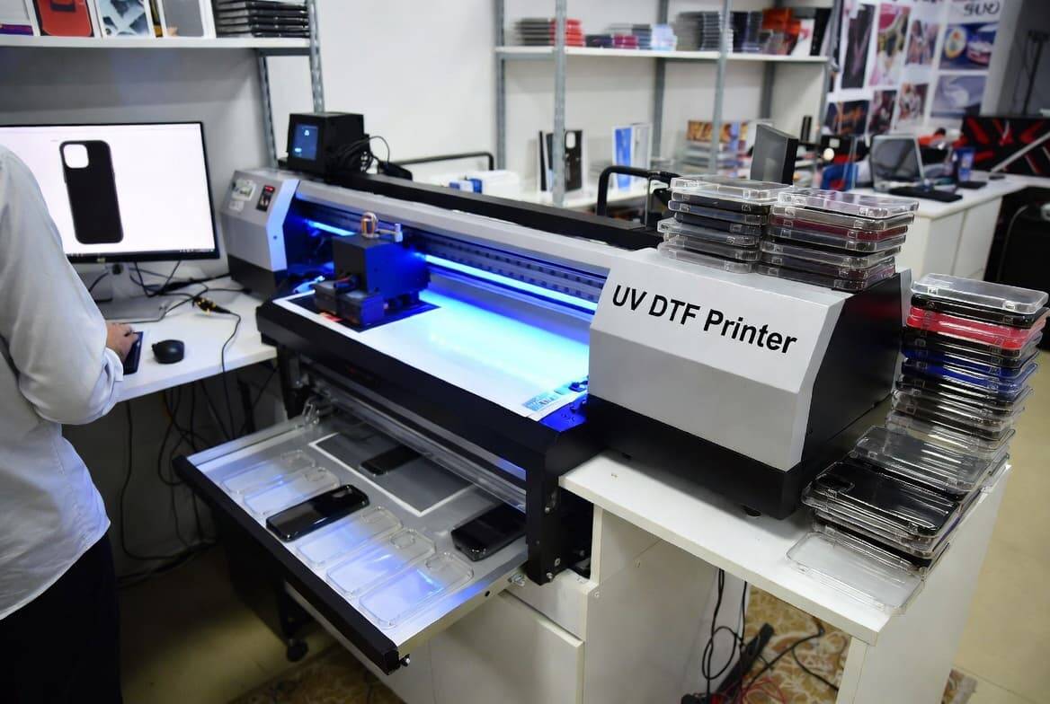 Small business workshop using UV DTF printer for custom product production
